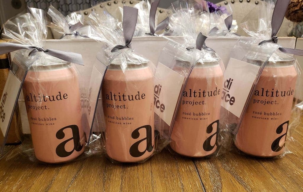 Sparkling rosé, wrapped and tagged with a luggage tag and the Diace Designs branding